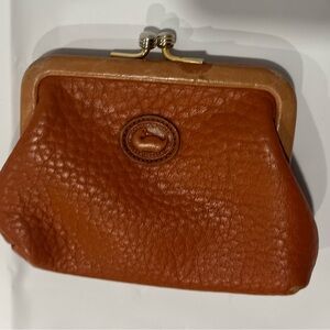 Dooney & Bourke Kiss lock coin purse. Good condition. Some wear on the corners.
